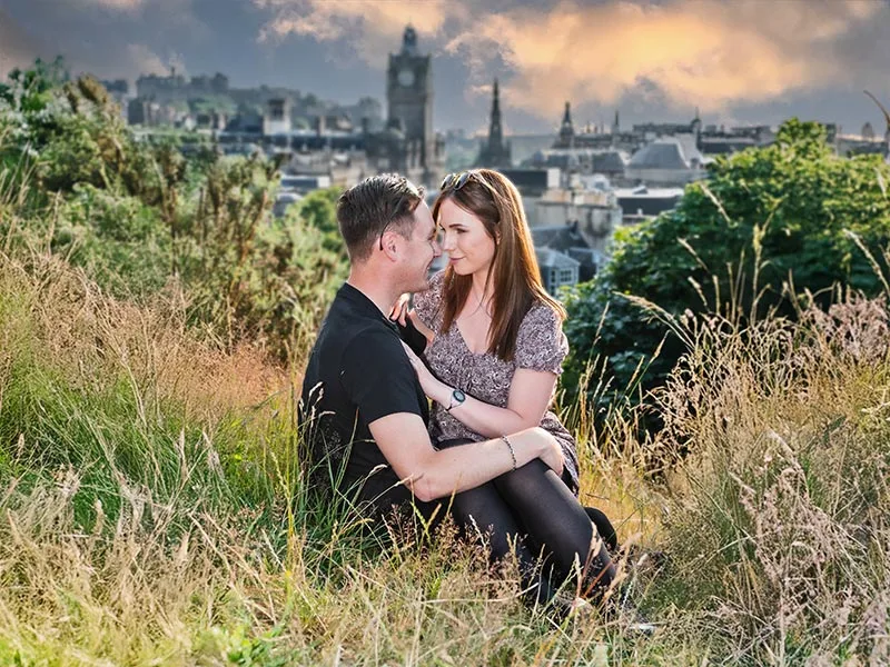 Couple portrait taken from Carlton Hill, Edinburgh looking toward Princes Street by portrait photographer in Edinburgh